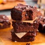 Healthy vegan sweet potato brownies with a fudgy texture and shiny chocolate glaze, stacked in a close-up food photography shot