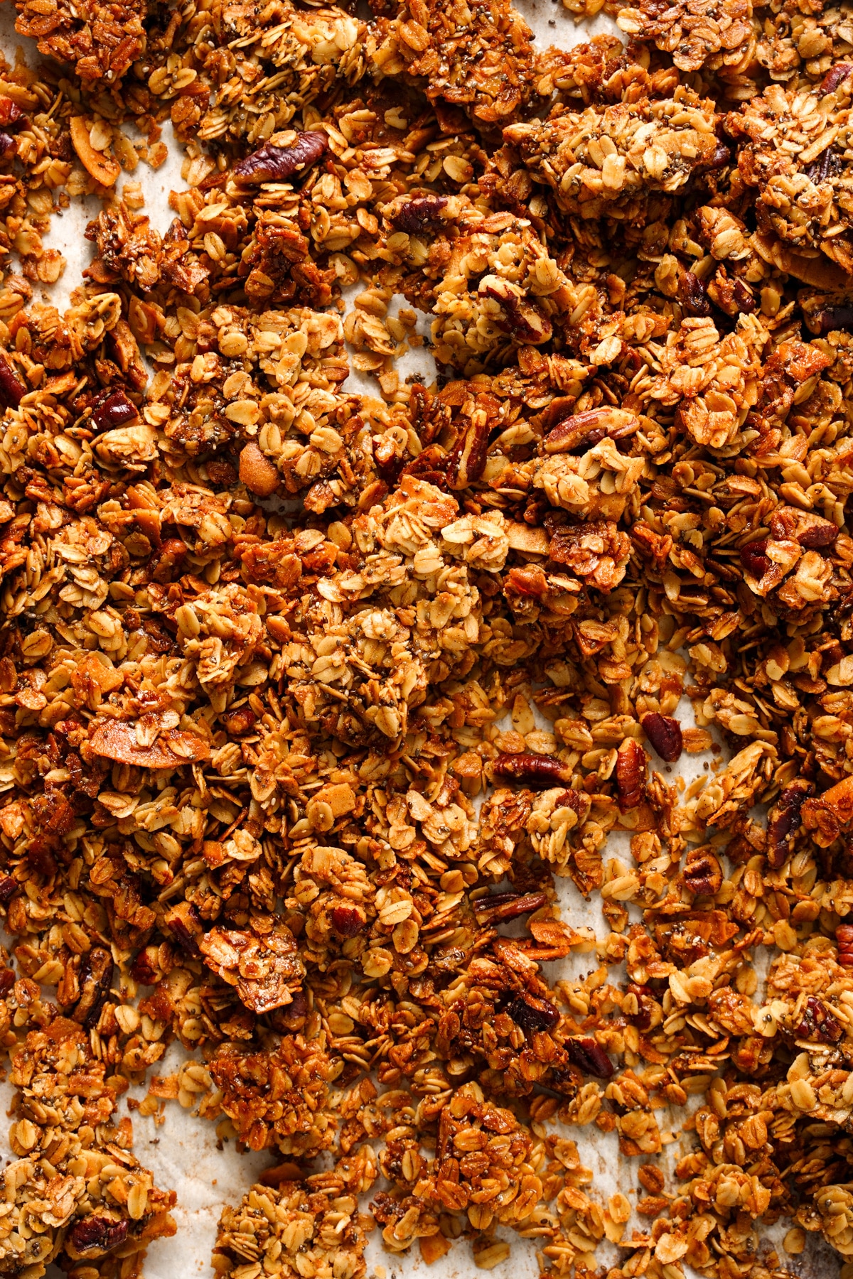 the coconut granola on parchment paper broken up into chunks