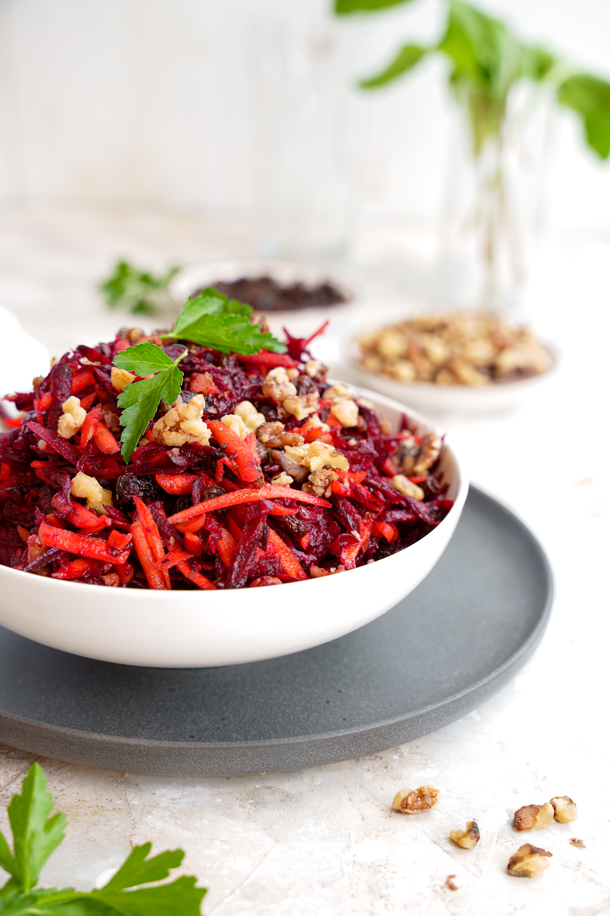 large bowl of the beer carrot salad with walnuts and parsley on top