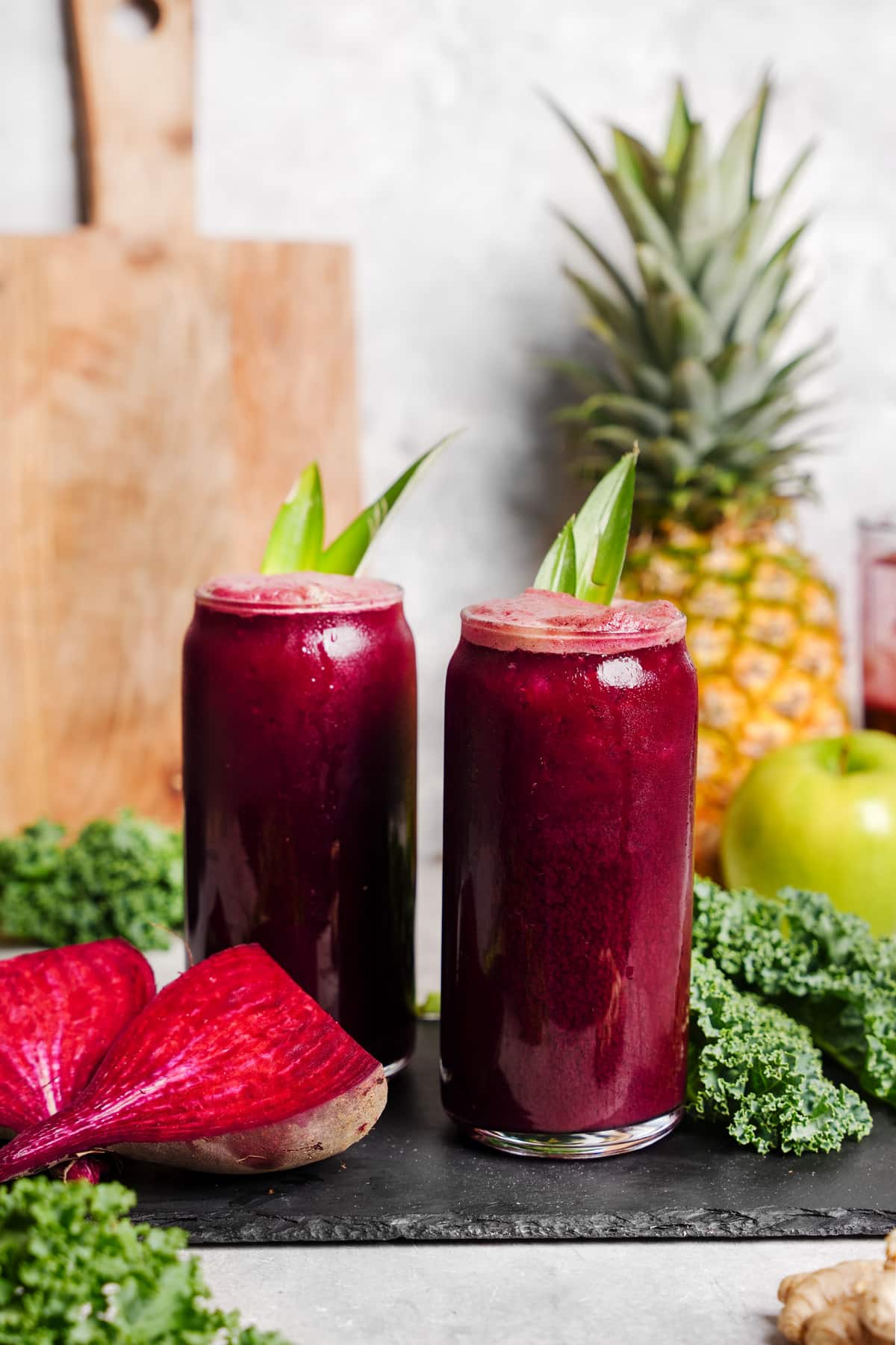 the kale beet juice poured over ice with. all the fresh ingredients around it