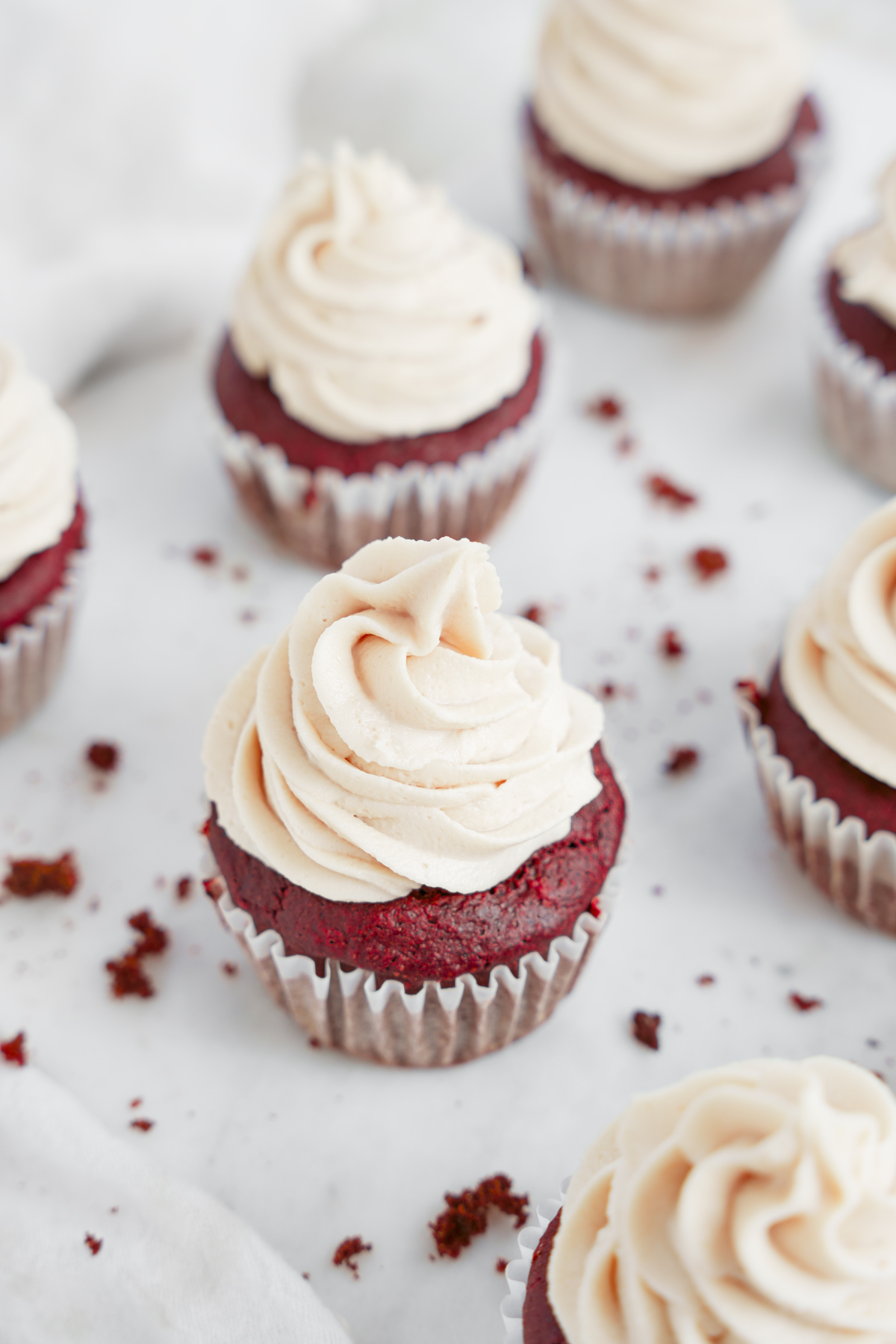 highlighting pipe-able healthy oil-free non-dairy cream cheese frosting on top of the cupcakes