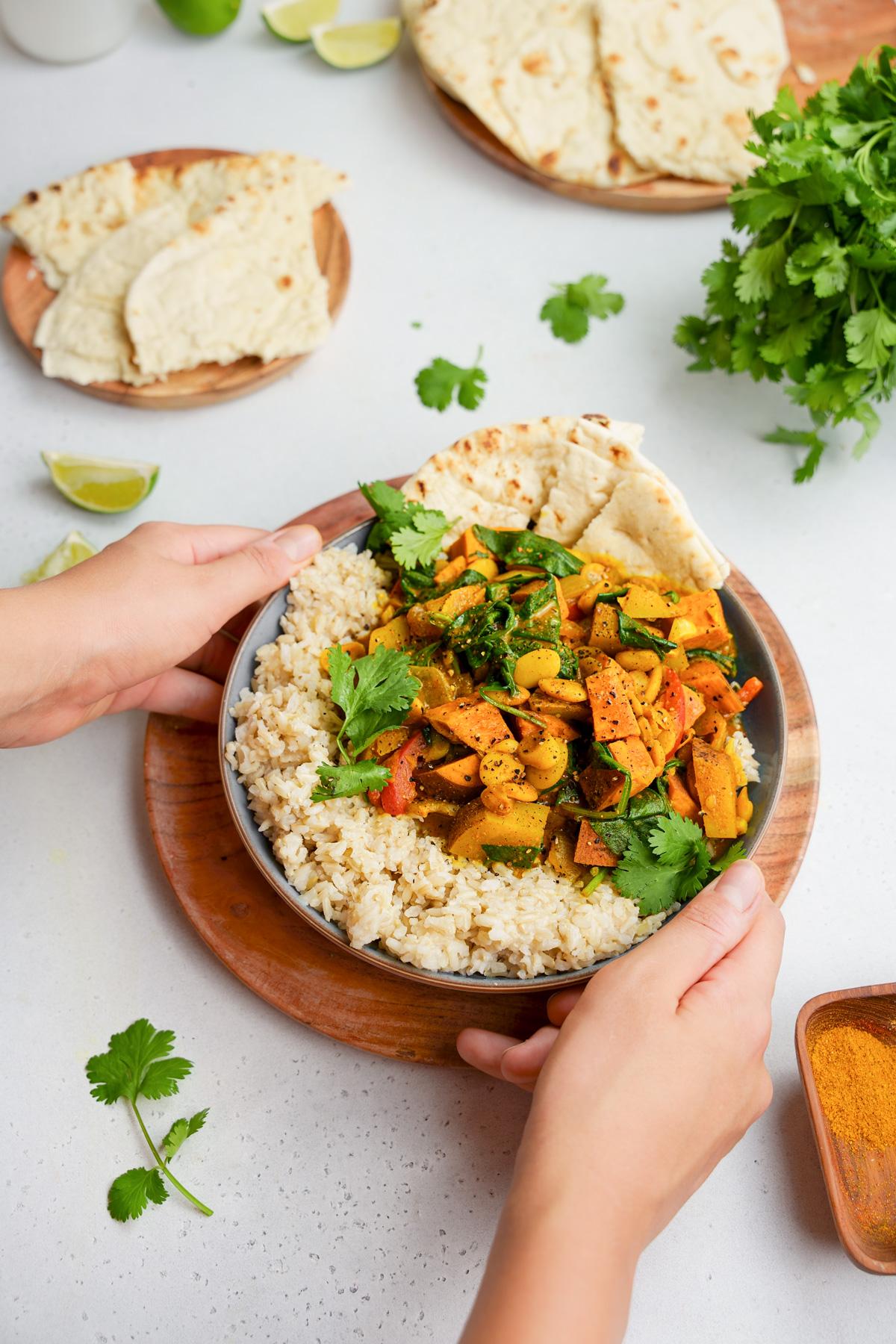 someone serving the Caribbean coconut vegan meal