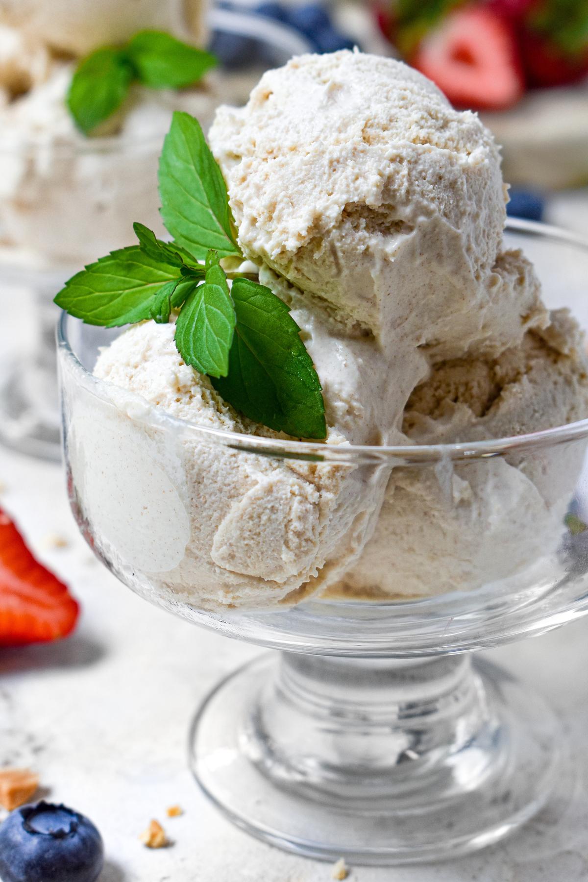 close up of the date sweetened ice cream with fresh fruit around it and a mint leaf