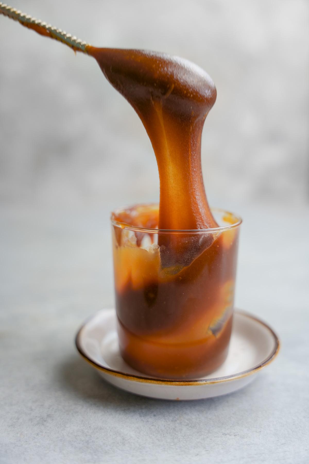 the date caramel being stretched to show the stretchy texture