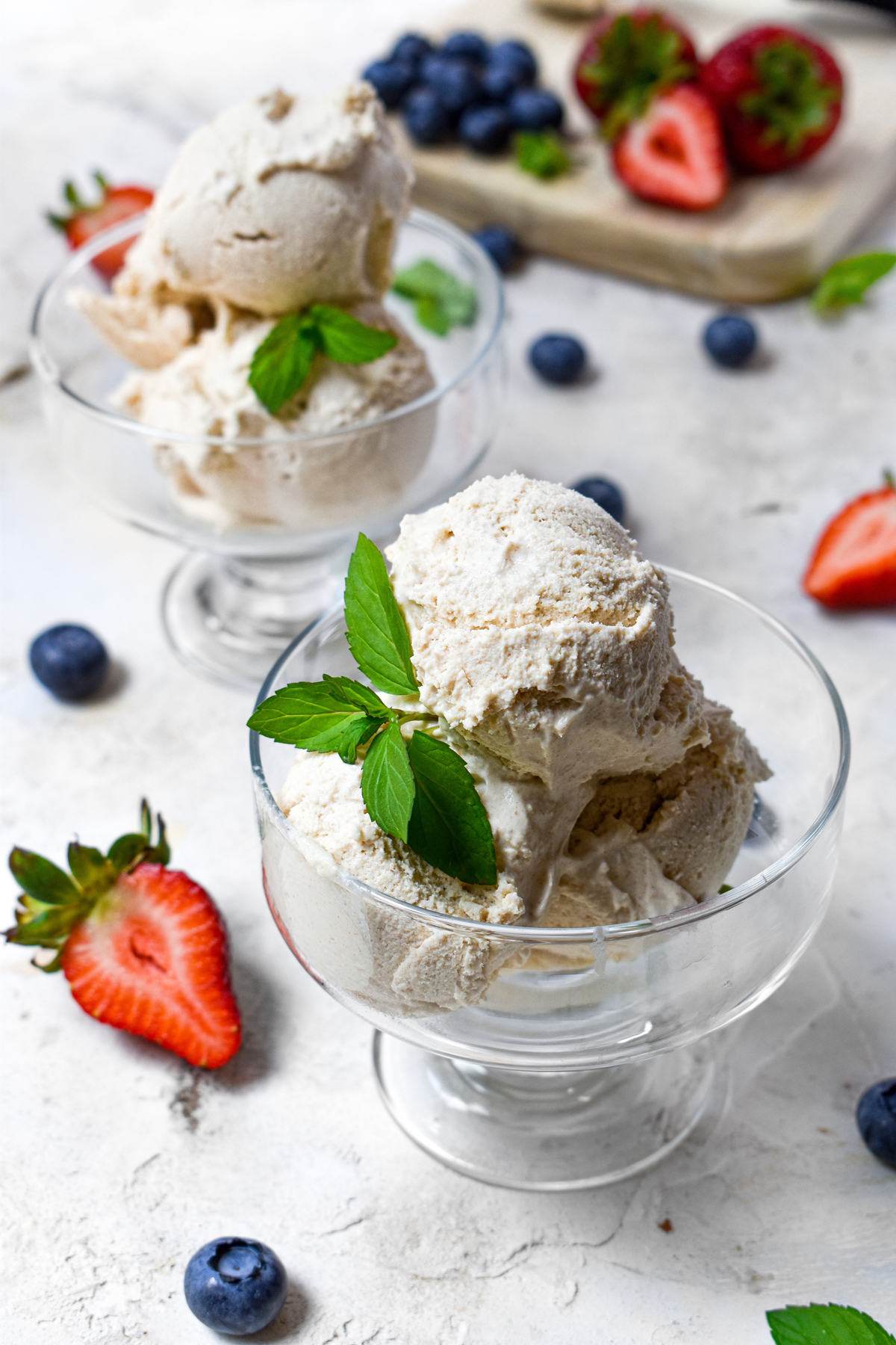 two bowls of the healthiest vegan ice cream with fresh fruit around them