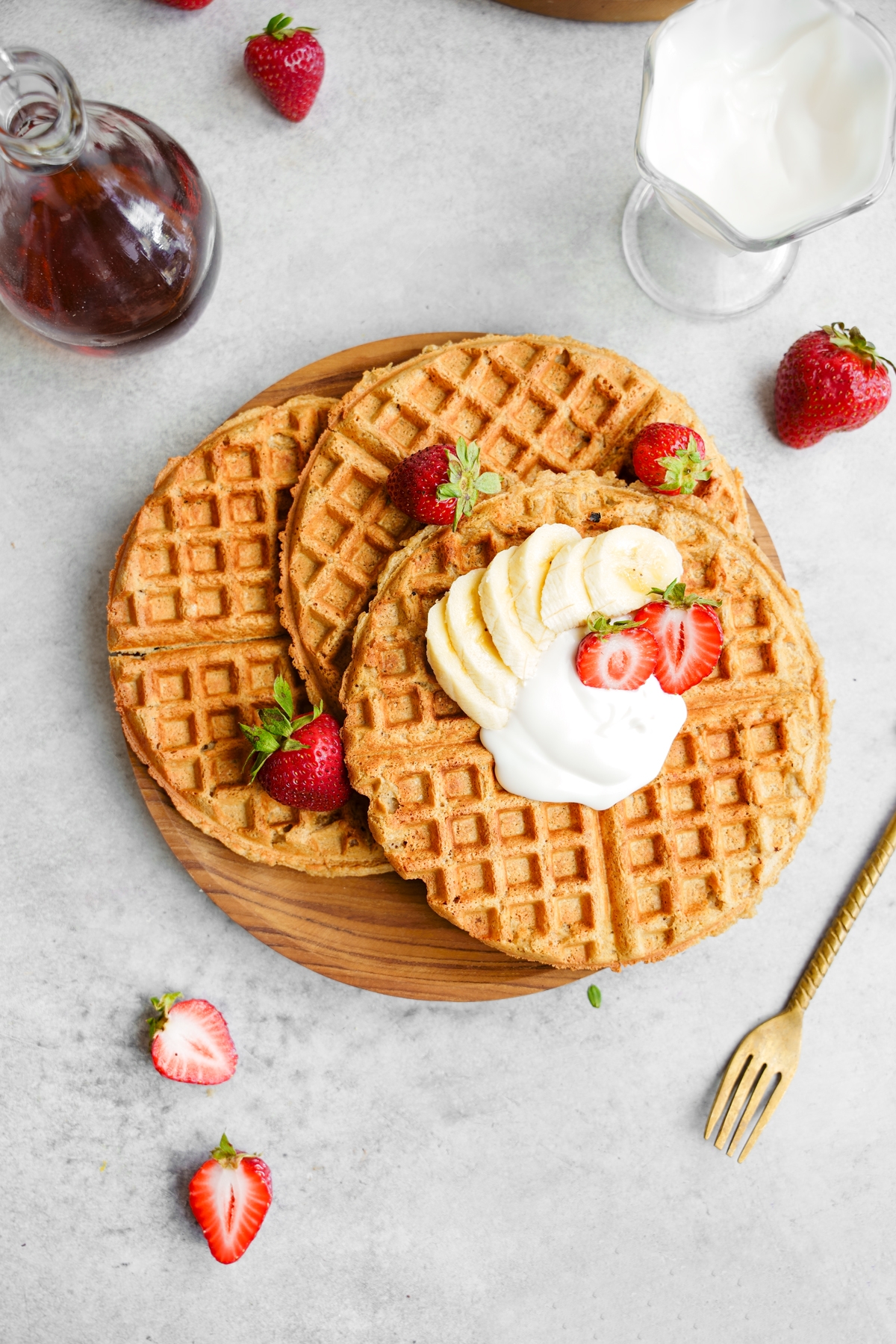 looking down at the vegan protein waffles with the vegan yogurt, strawberries and bananas on top