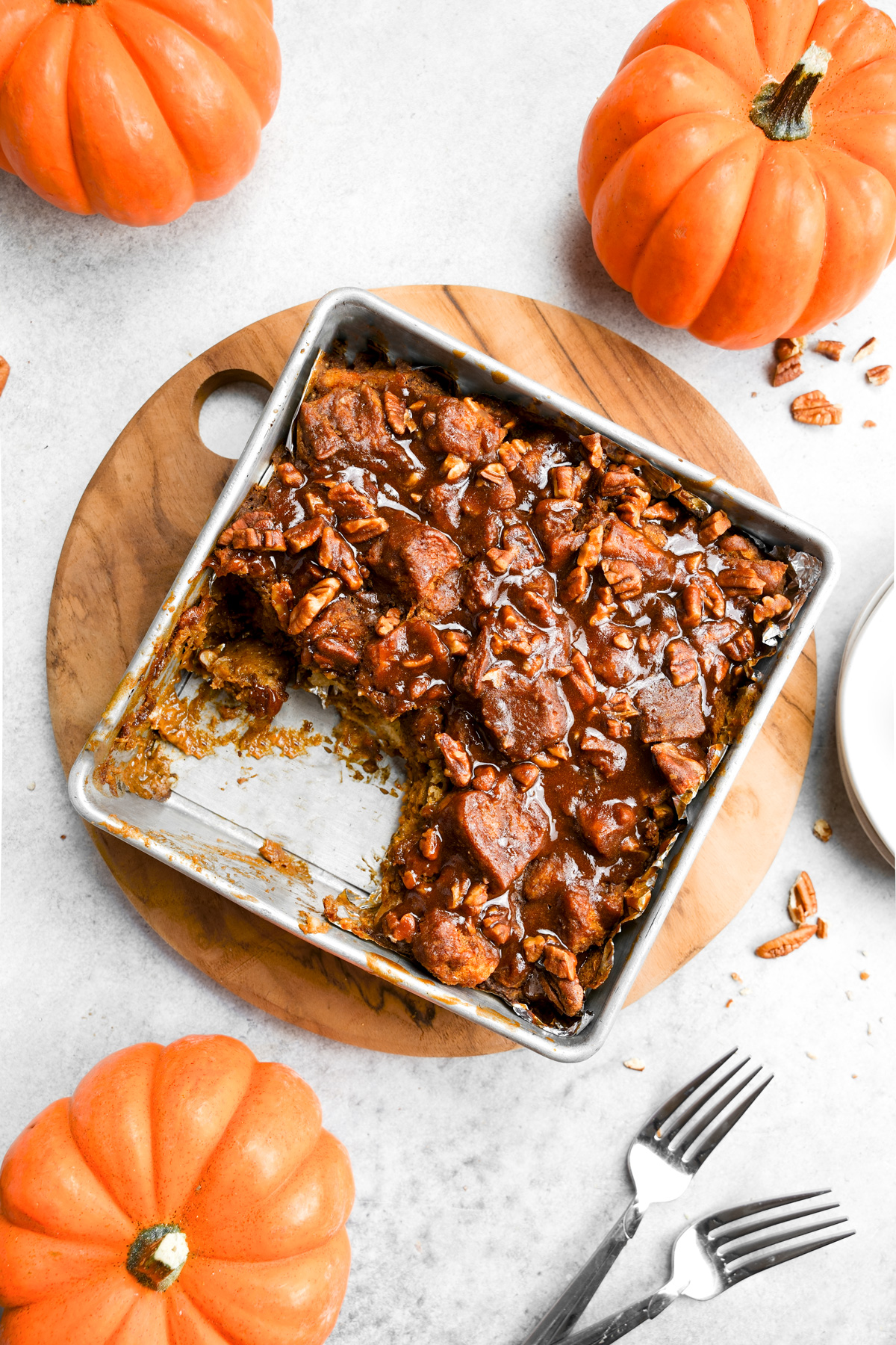 the vegan pumpkin bread pudding with a scoop taken out of it