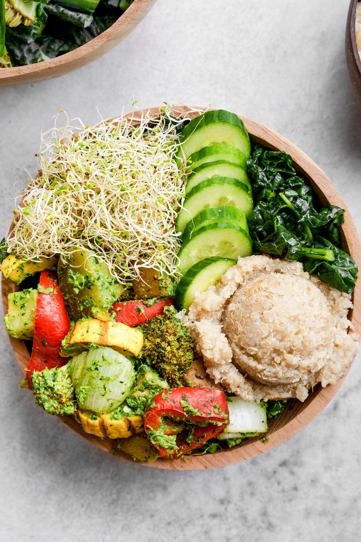 close up of the pesto buddha bowl to show the roasted vegetables and quinoa