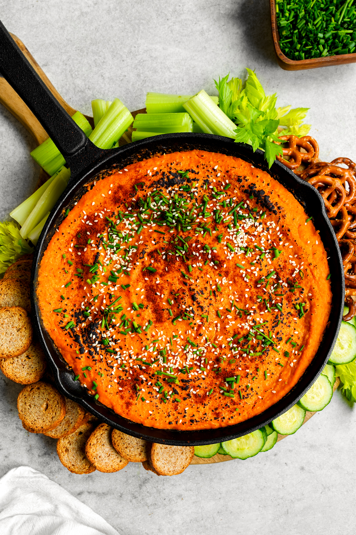 the butternut squash dip topped with pretzels, chips, cucumbers, and celery