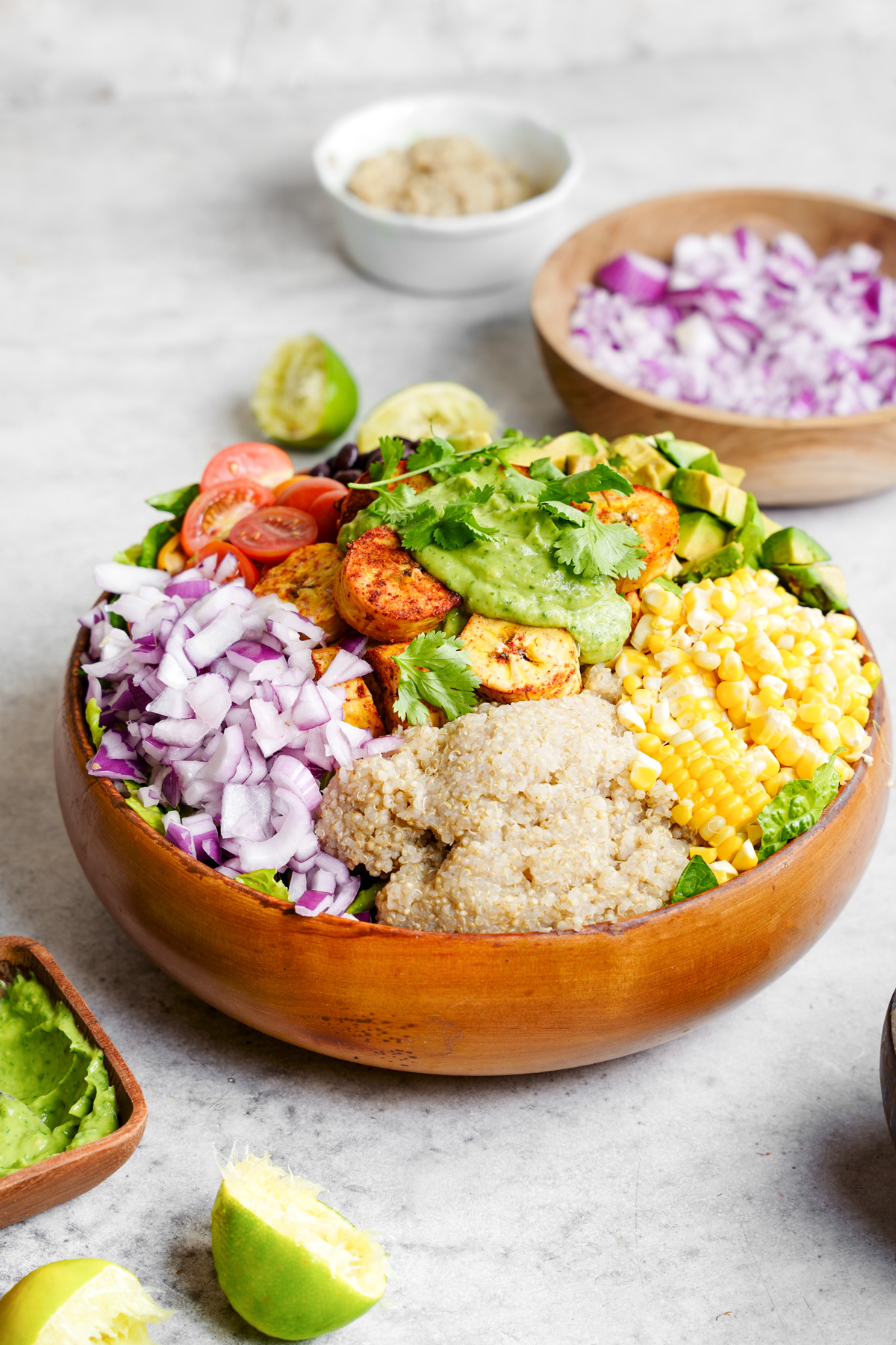 vegan plantain salad with plantains, corn, quinoa, onions, cherry tomatoes, and avocados, with a creamy cilantro lime dressing
