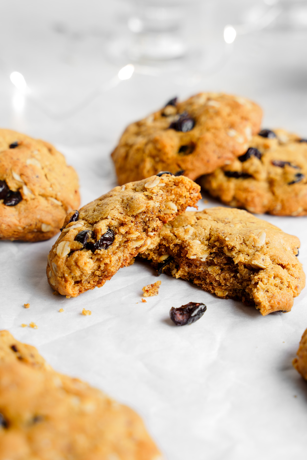 the vegan oatmeal cranberry cookies broken in half to show the chewy texture