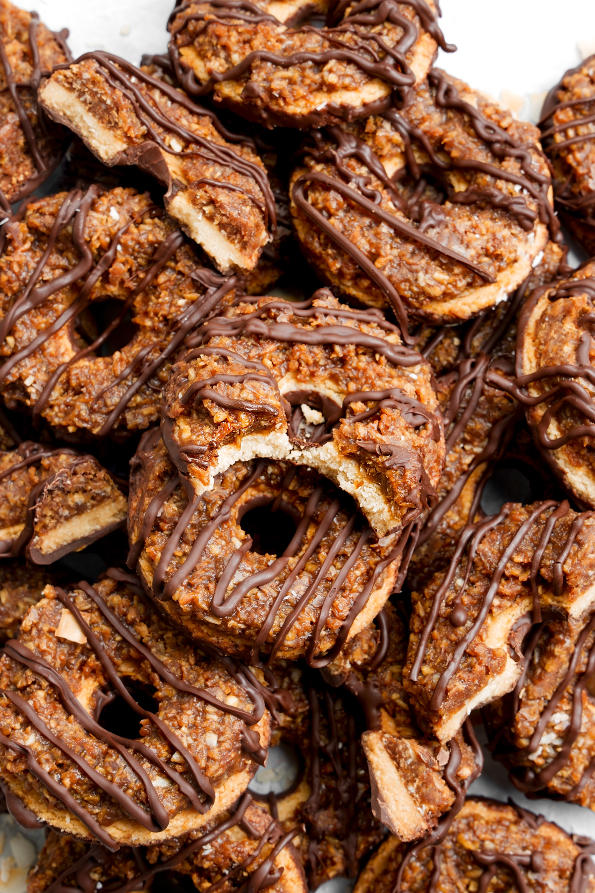 looking down at the cookies piled on top of each other with one that has a bite taken out of it
