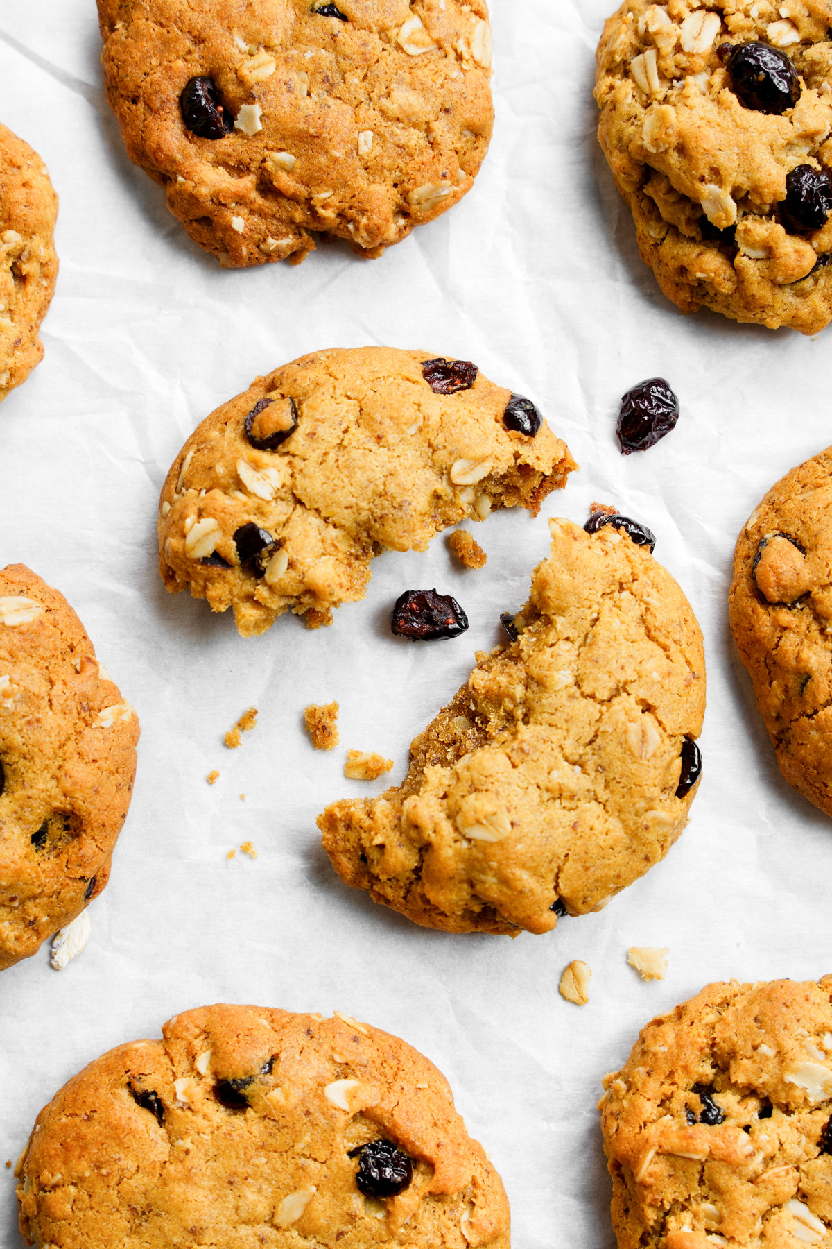 the vegan oatmeal cranberry cookies split in half to show the chewy cookie texture