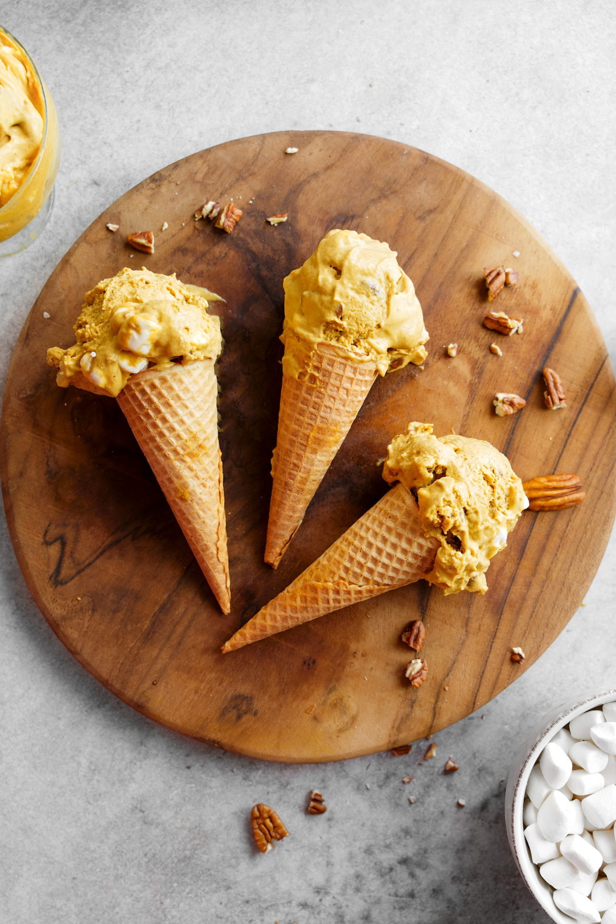 the vegan fall dessert in cones with marshmallows and pecans around it