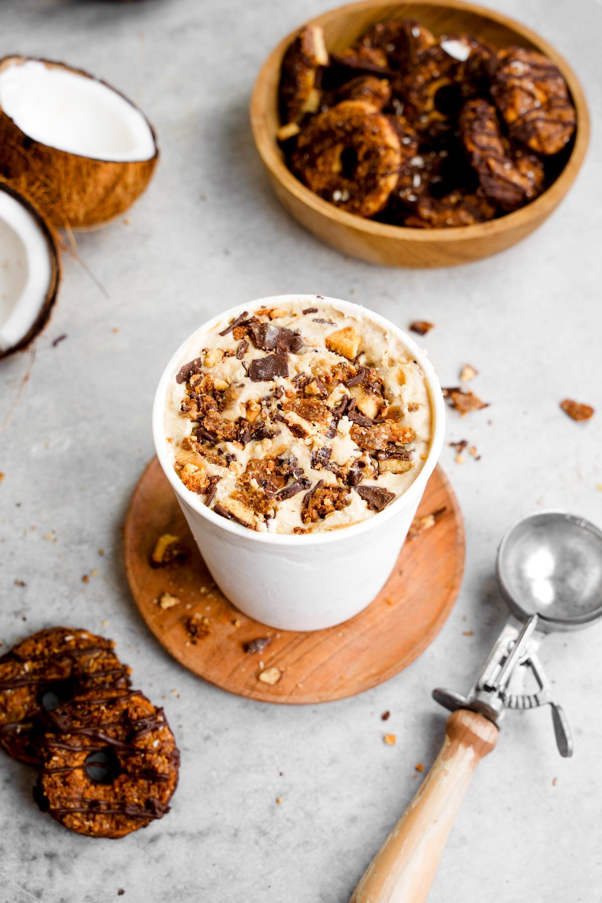 the girl scout cookie ice cream in an ice cream container with cookies around it