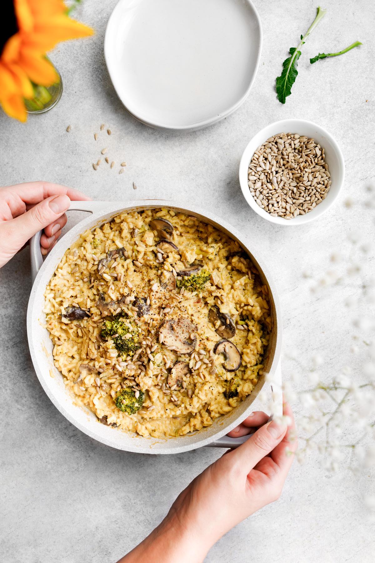 someone serving the sunflower seed risotto