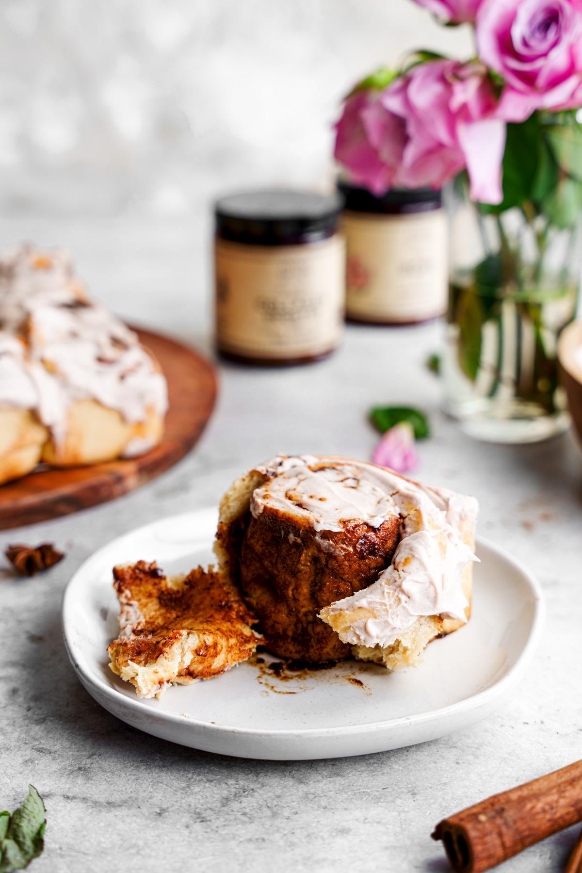 the dirty rose chai cinnamon roll cut into to show the gooey filling