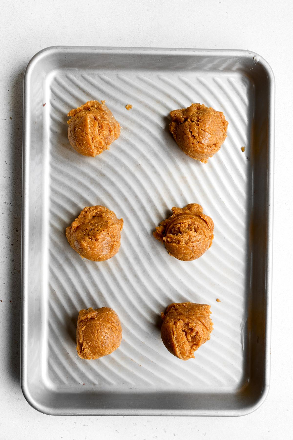 scooping the cookies onto the sheet pan
