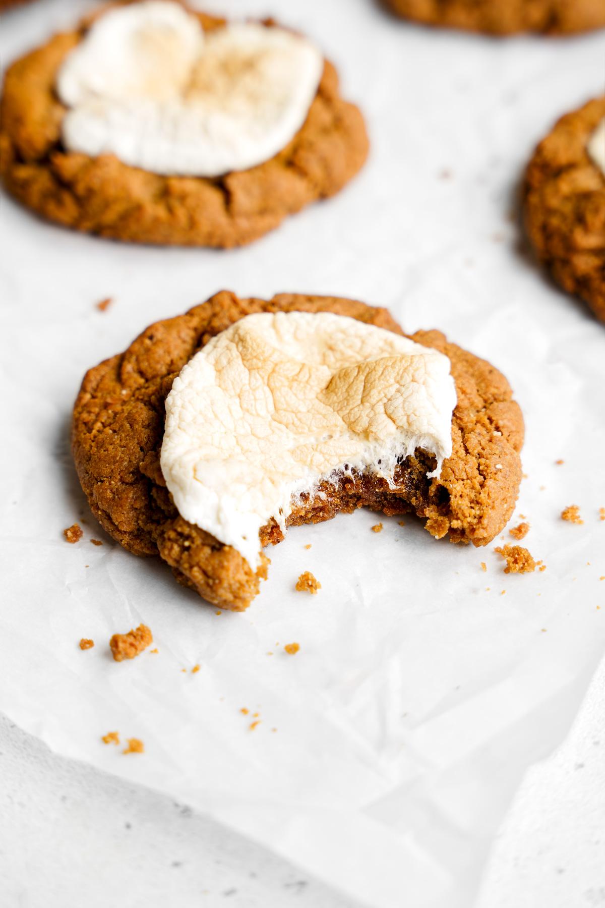 close up of the peanut butter marshmallow cookies with a bite taken out of one to show the soft and chewy center