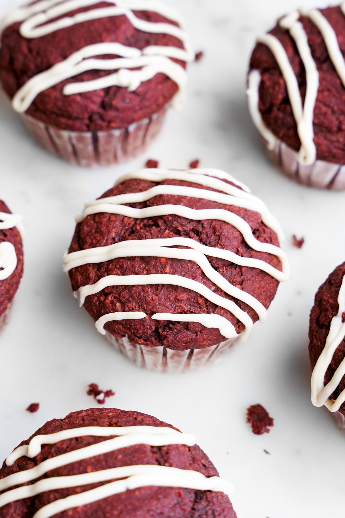 looking down at the red velvet muffins with the cream cheese glaze on top