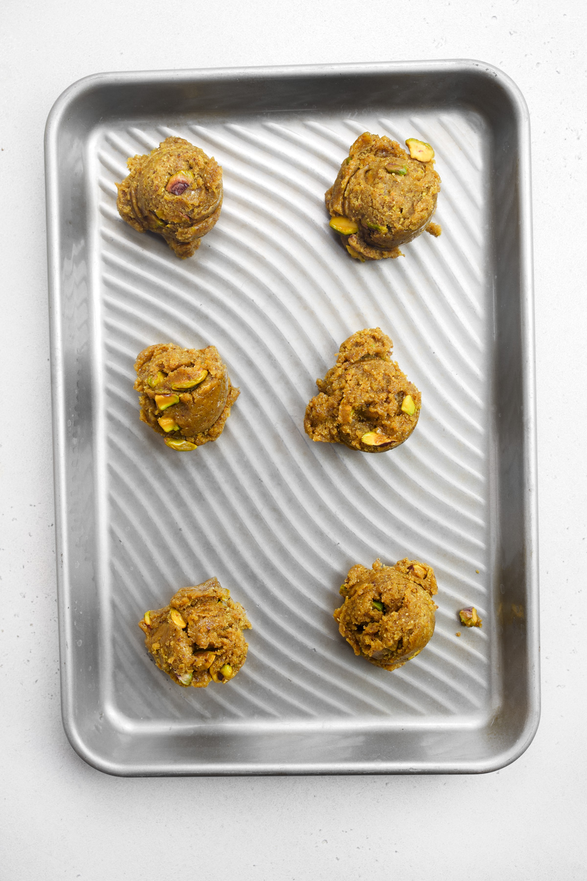 scooping the cookies onto a baking tray
