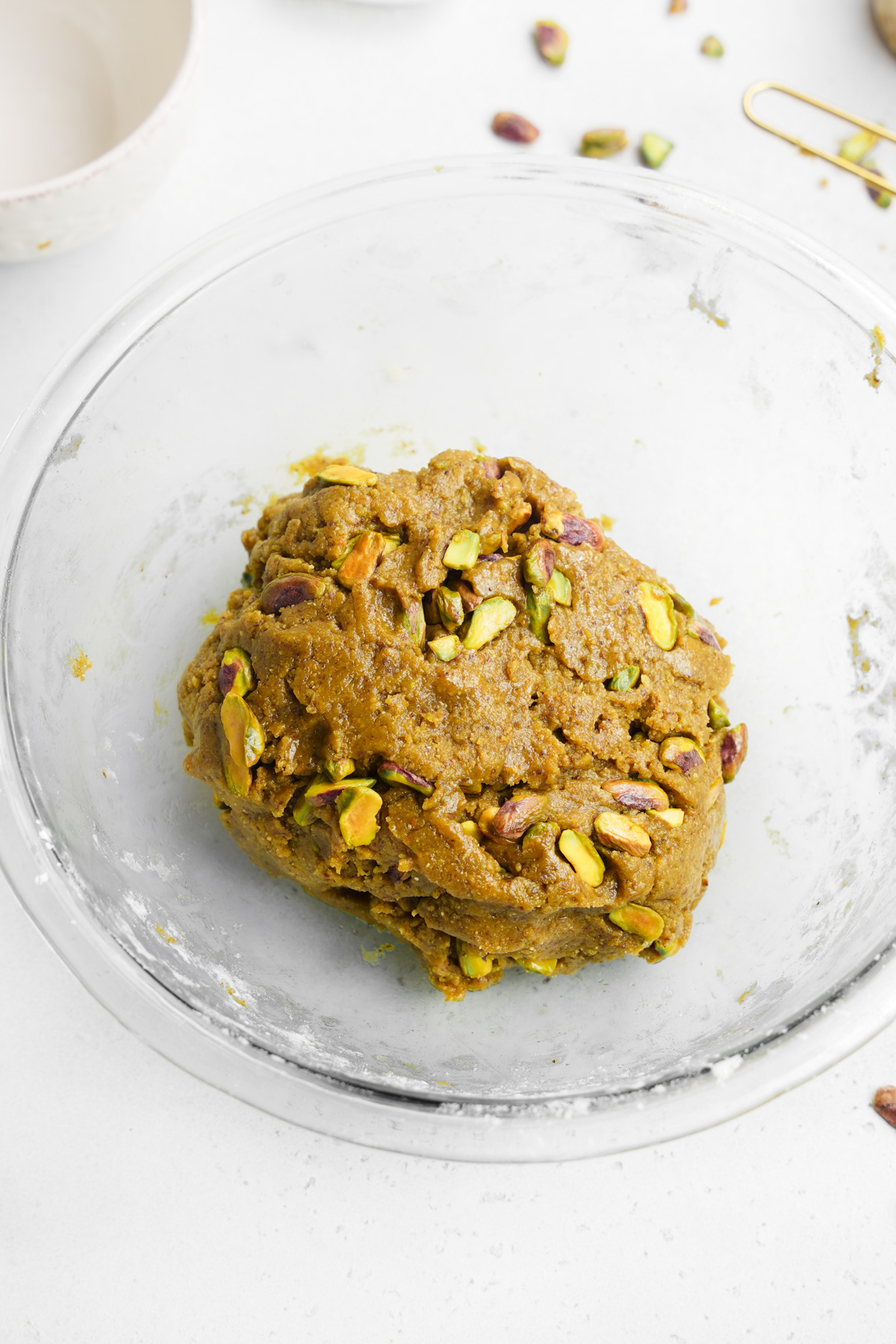adding the pistachios to the dough