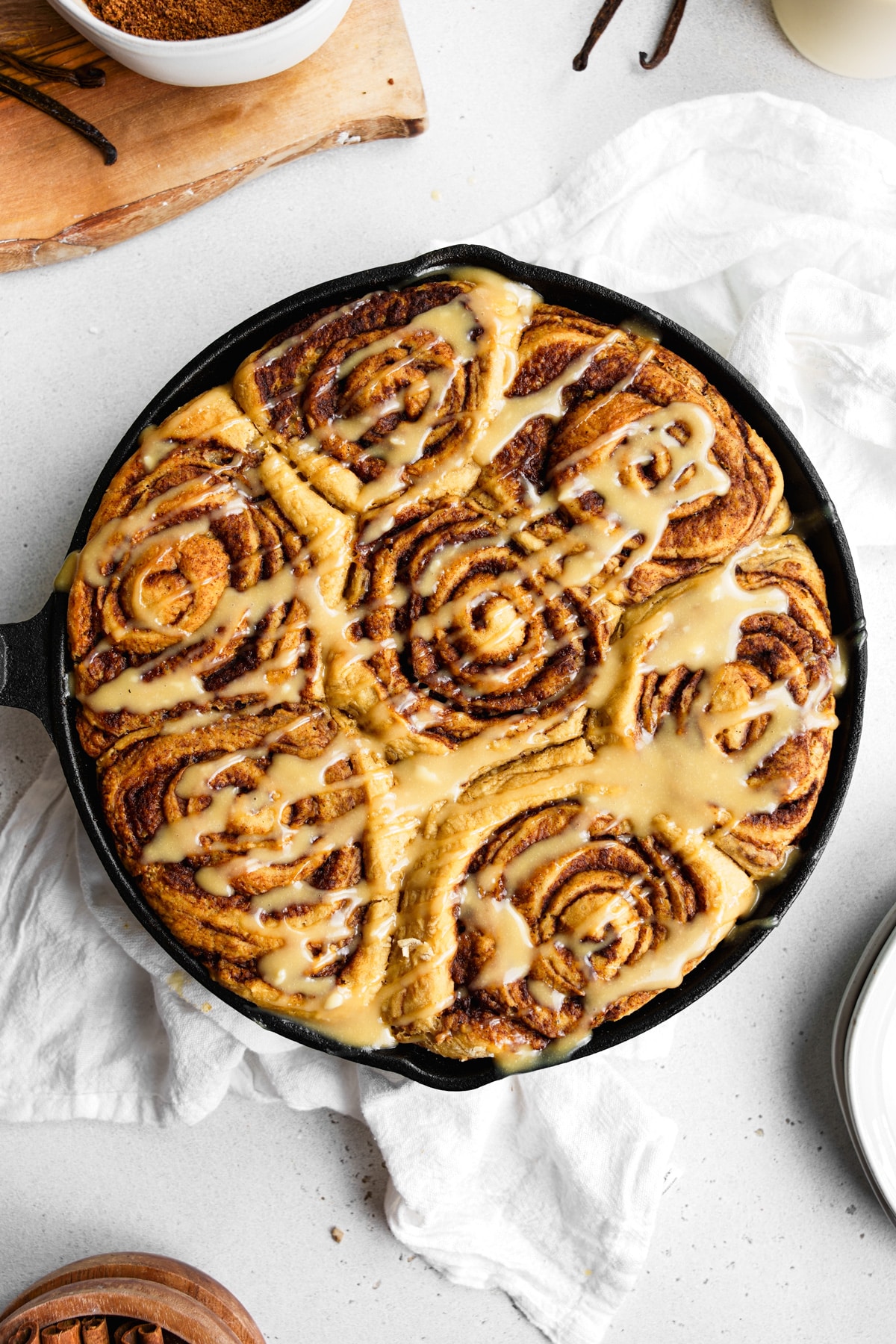 looking down at the protein cinnamon rolls with the cream cheese icing drizzled on top