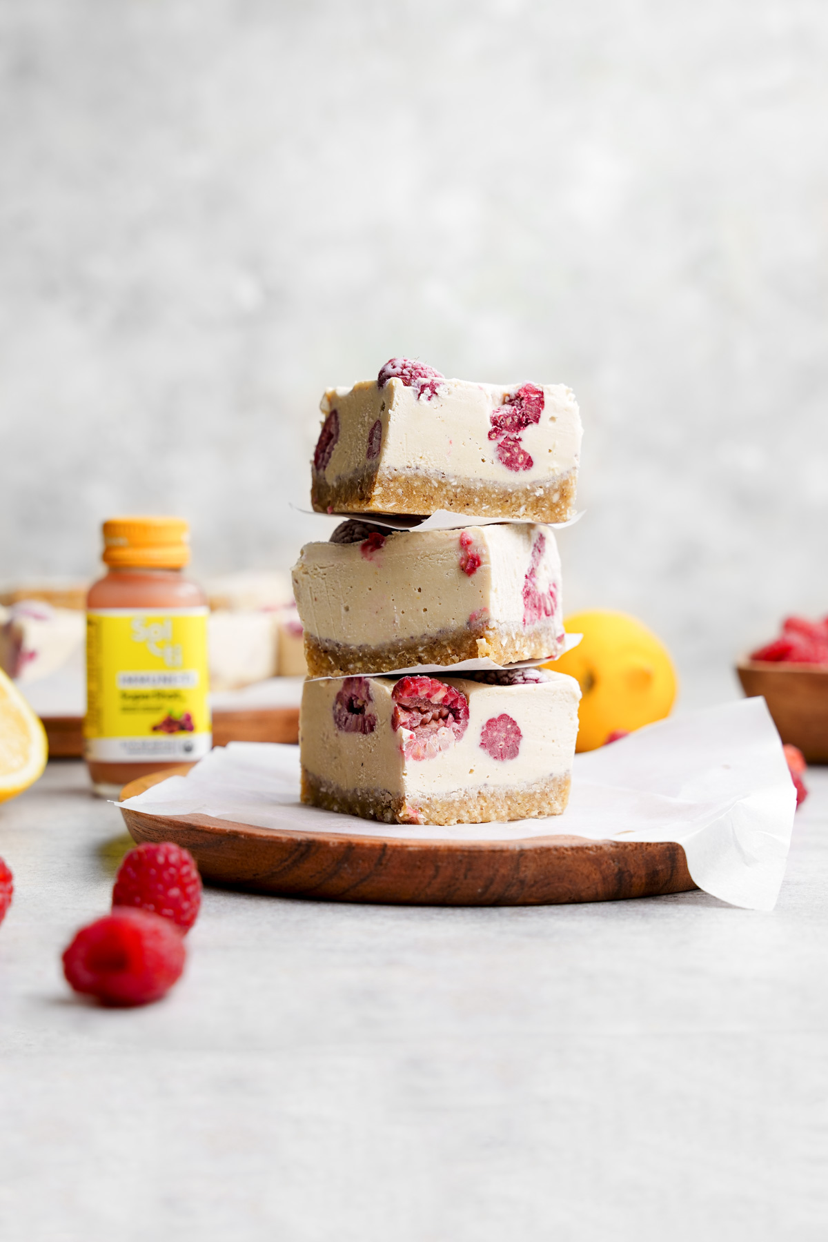 the raw vegan dessert stacked on top of each other with the sol-ti immunity bottle in the background