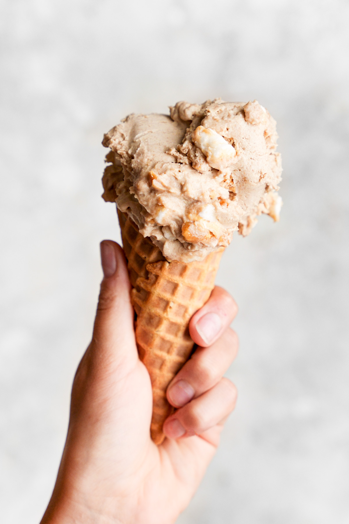 holding up a cone of the homemade vegan ice cream