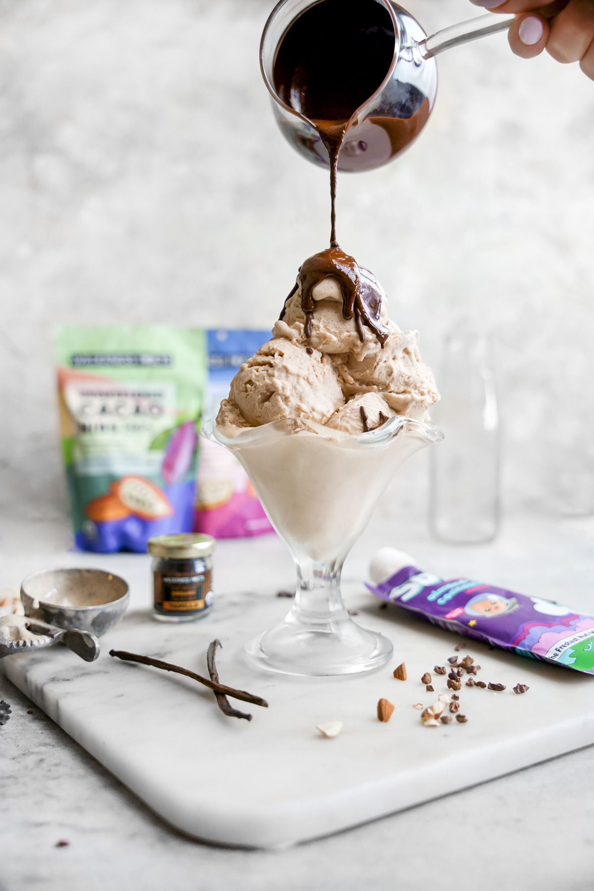 pouring the vegan magic shell onto the vanilla bean ice cream