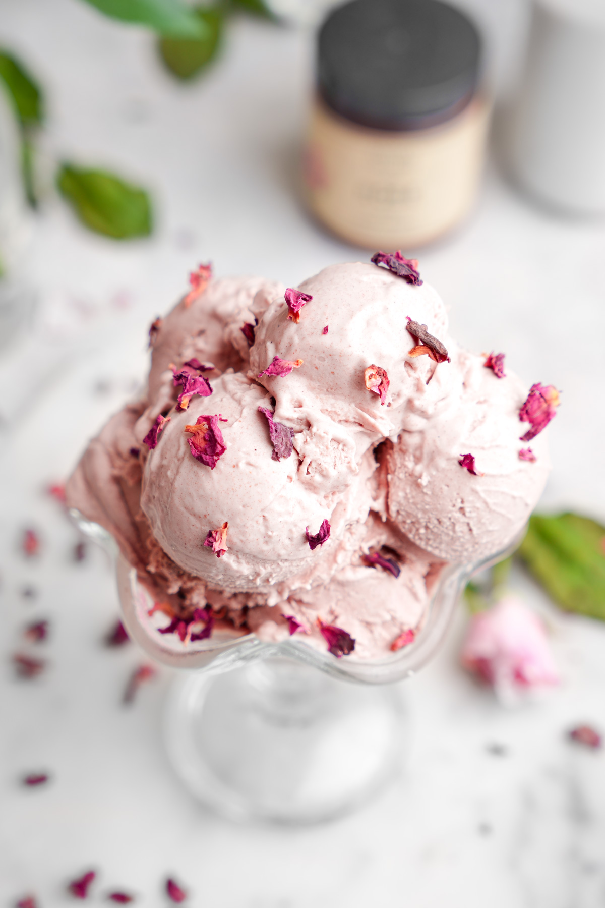 close up of the rose ice cream with fresh rose petals on top