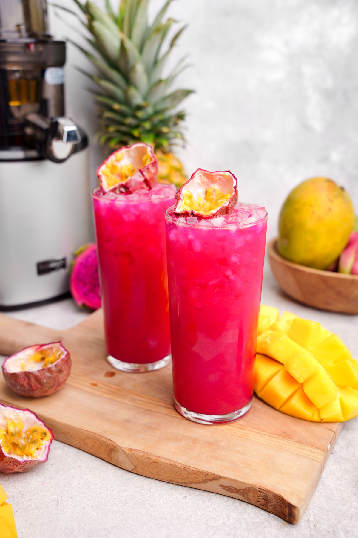 looking down at the tropical fruit punch juice with fresh fruits all around it