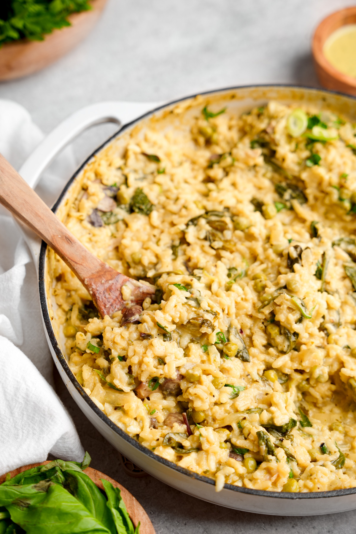 a close up of the mixed up risotto with a wooden spoon in it