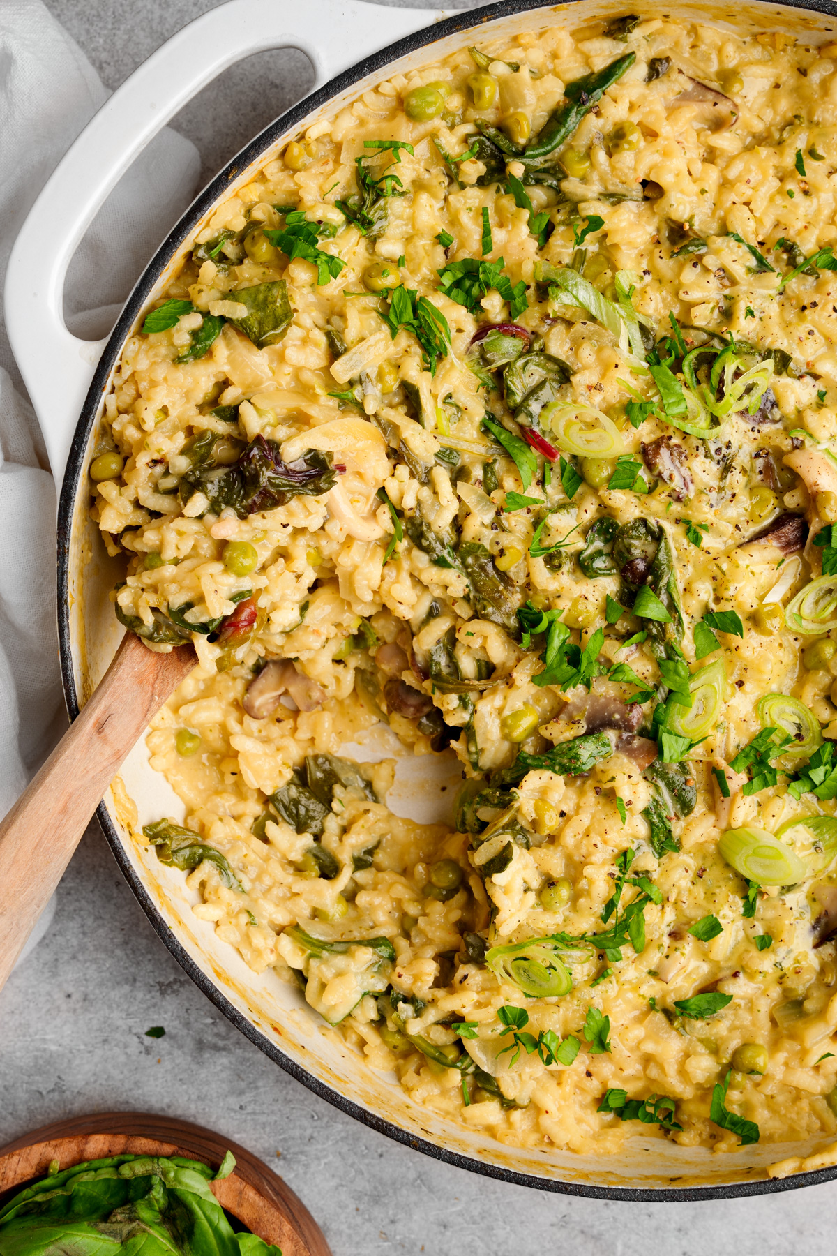 close up of the vegan risotto with a wooden spoon scooping it out
