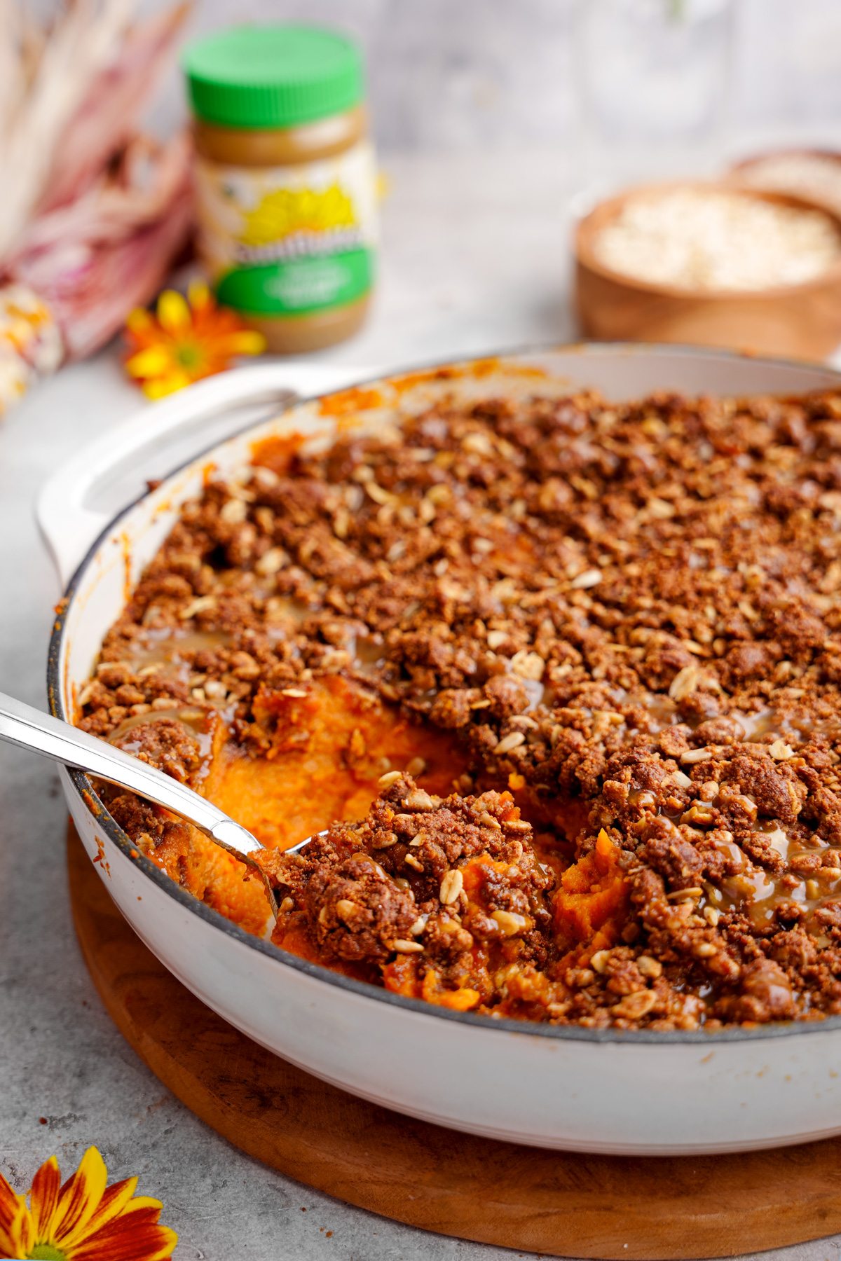 looking head on at the gluten-free sweet potato casserole with a spoon scooping out the mixture