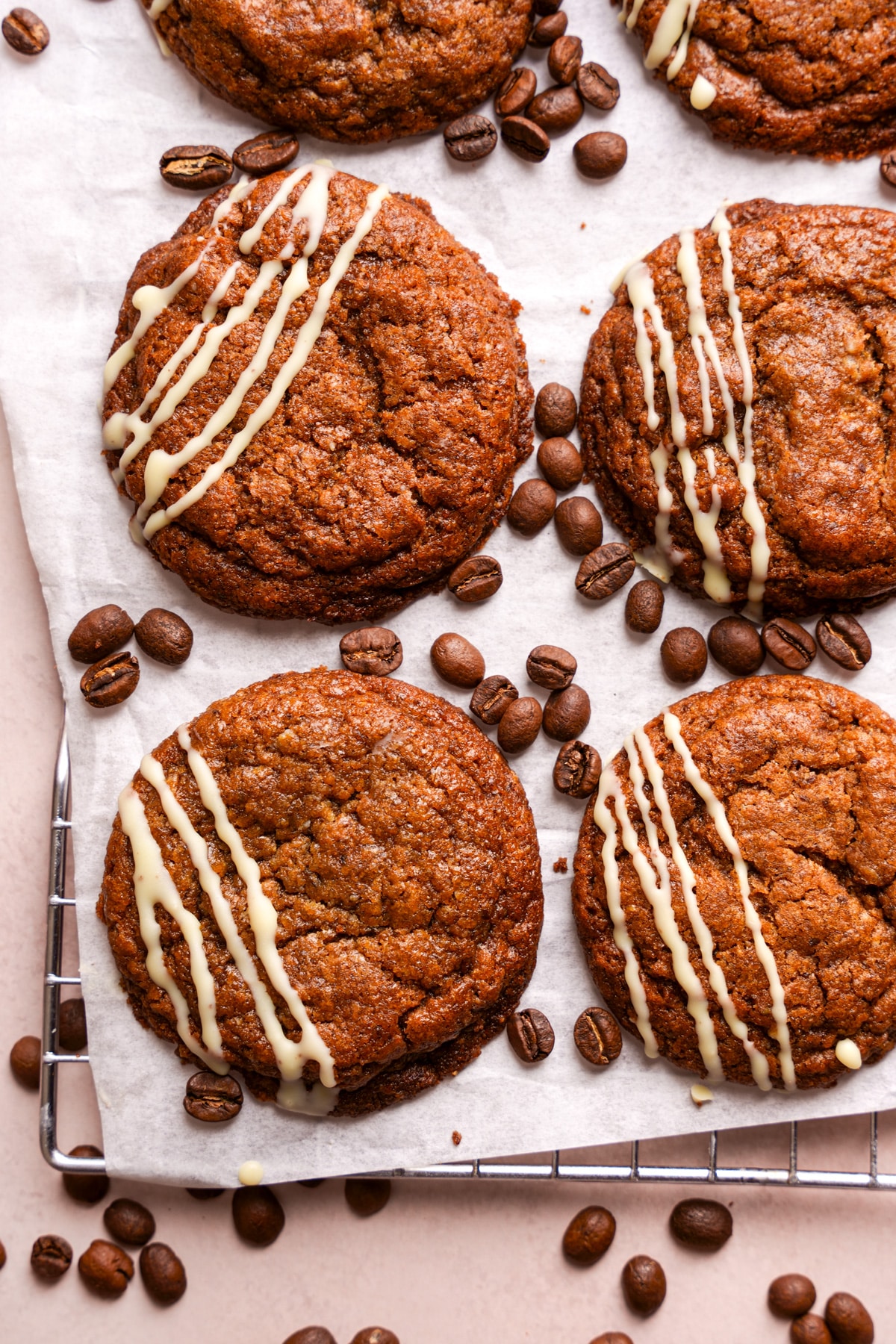 looking down at the coffee cookies cooling on the wire rack with espresso beans around them