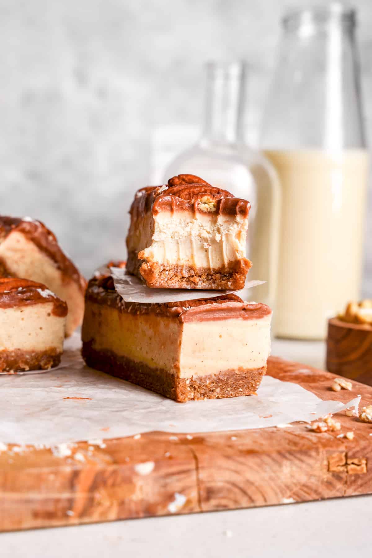 the caramel ice cream bars stacked on top of each other with a bite taken out of the top one