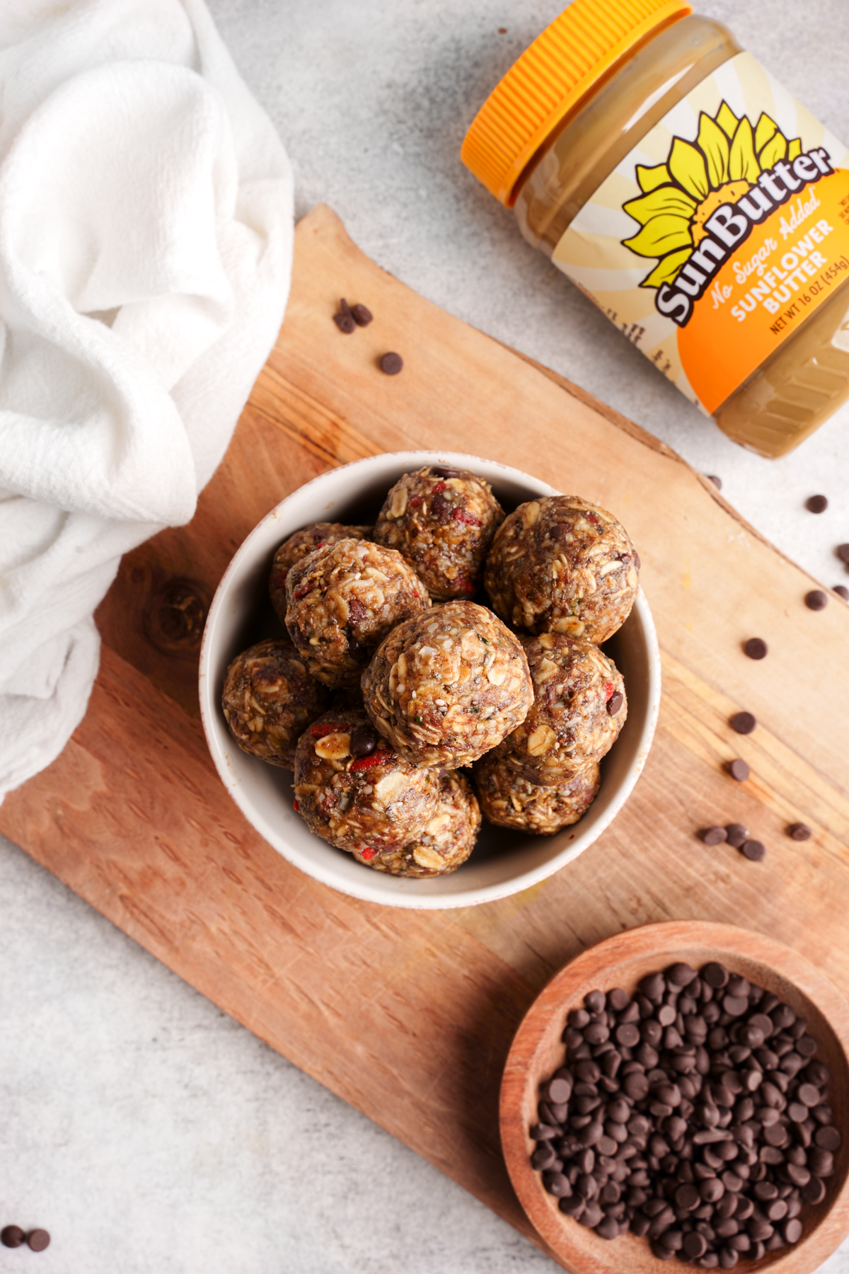 looking down at the bowl of energy bites with the sunbutter container next to it