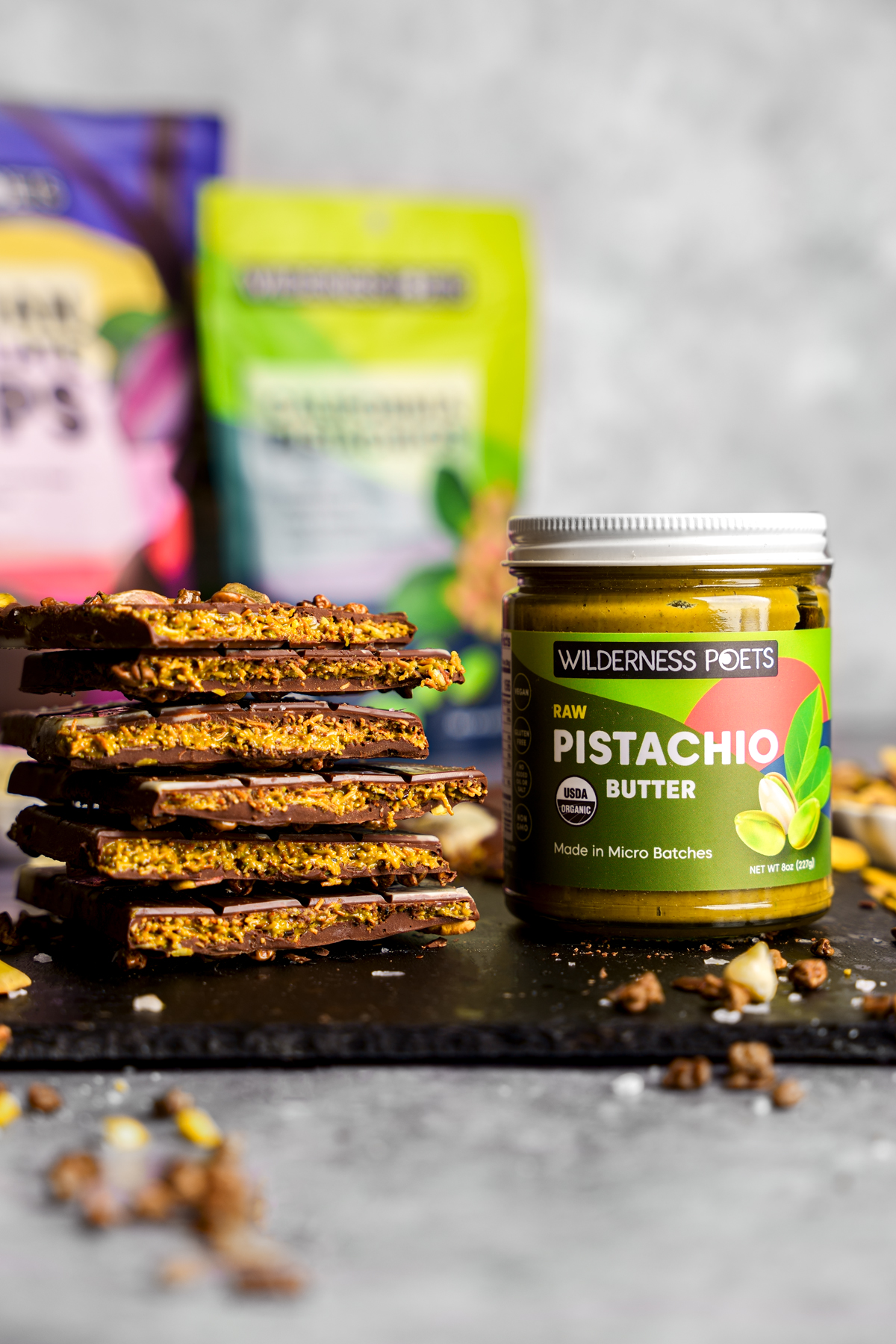 the stack of chocolate bars next to the pistachio butter