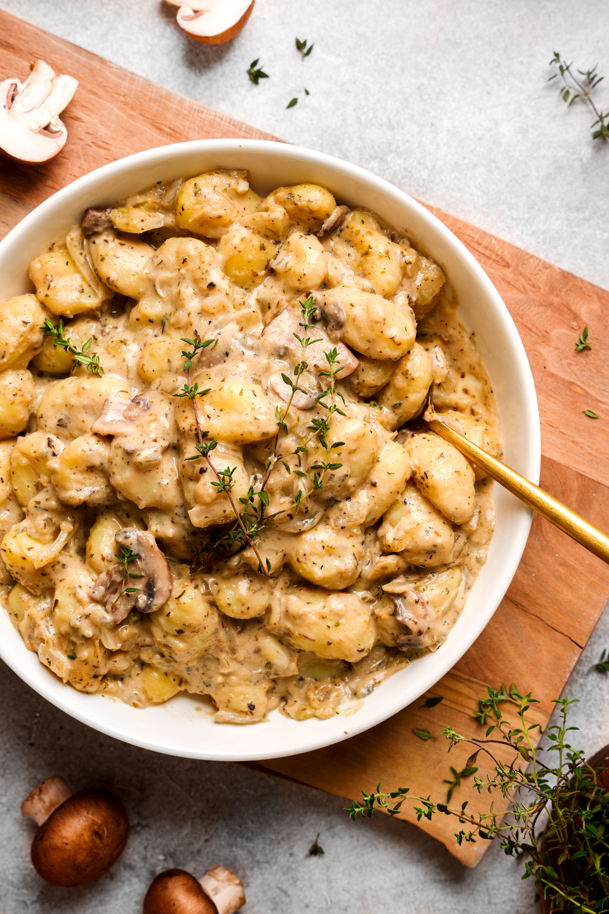 looking down at the creamy vegan gnocchi with a spoon in it