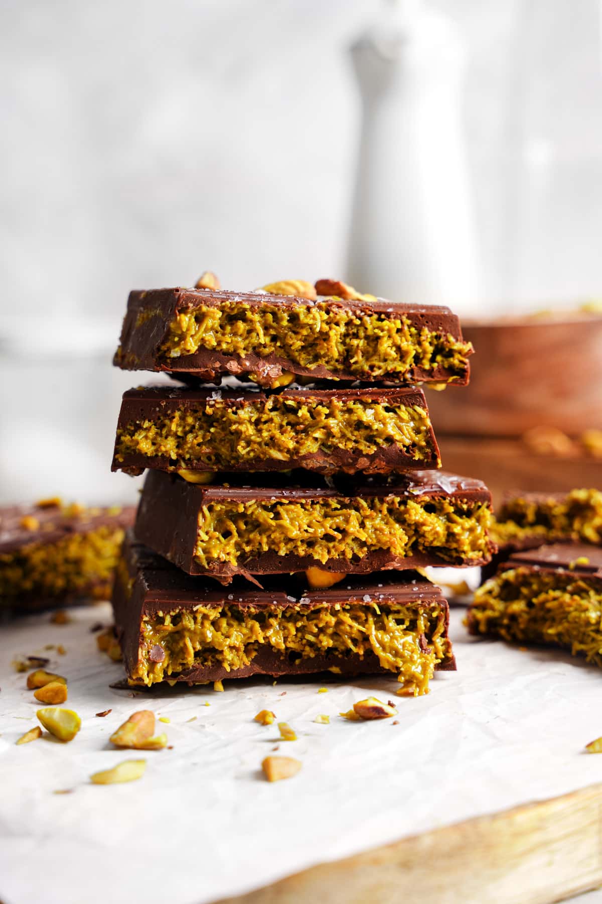 the dubai chocolate bars split in half and stacked on top of each other to show the pistachio pastry layer