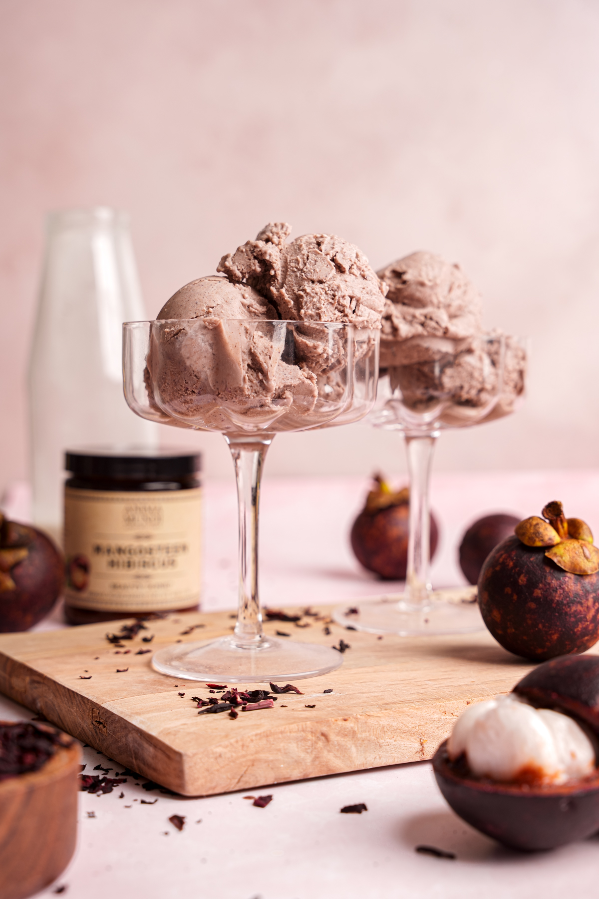 the anima mundi mangosteen hibiscus ice cream with fresh mangosteens around it
