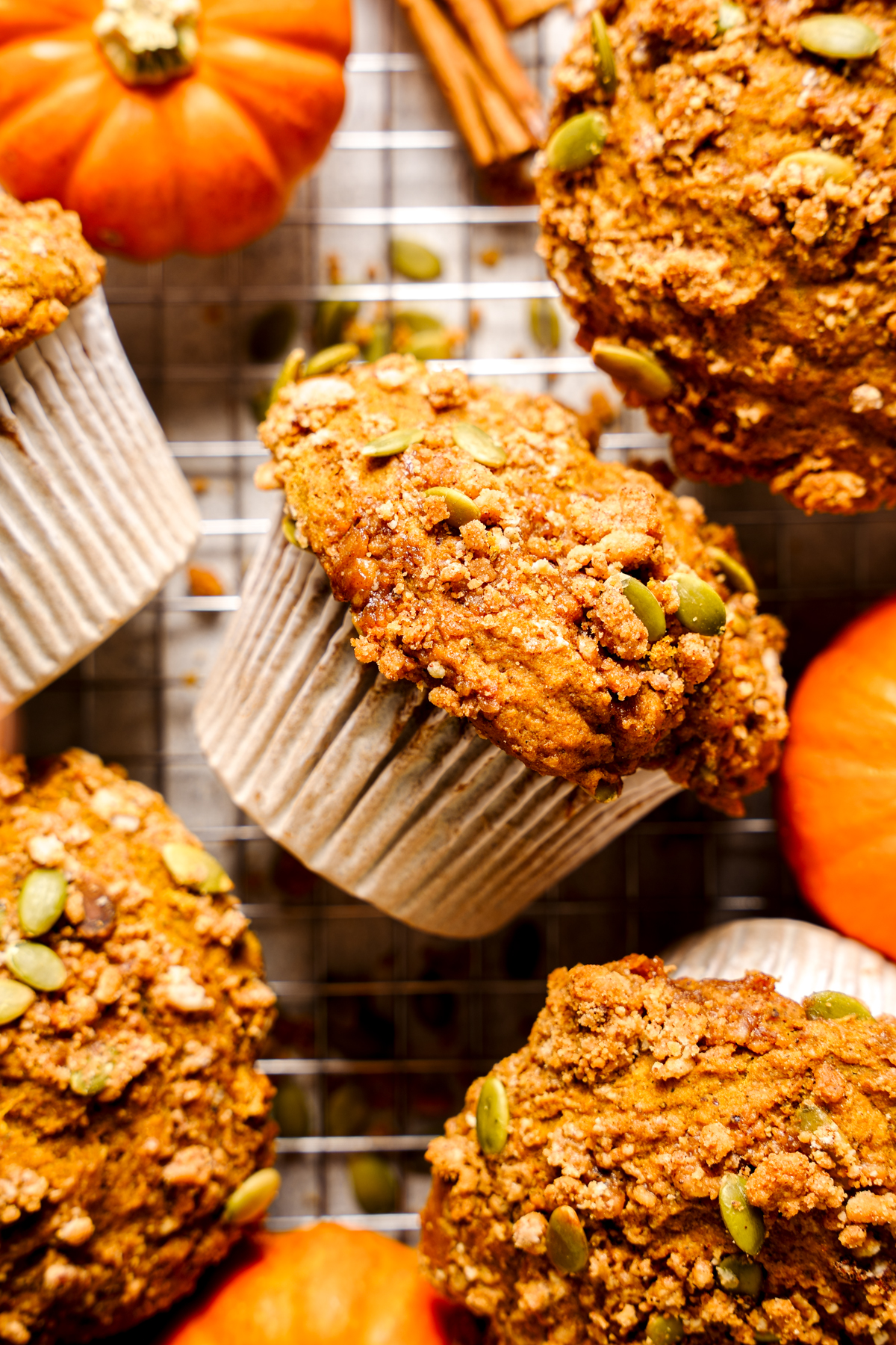 looking down at the pumpkin muffins turned on its side with pumpkins and streusel around it