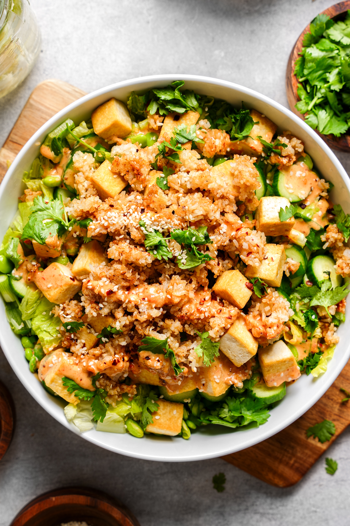 the crispy rice salad topped with dressing and sesame seeds
