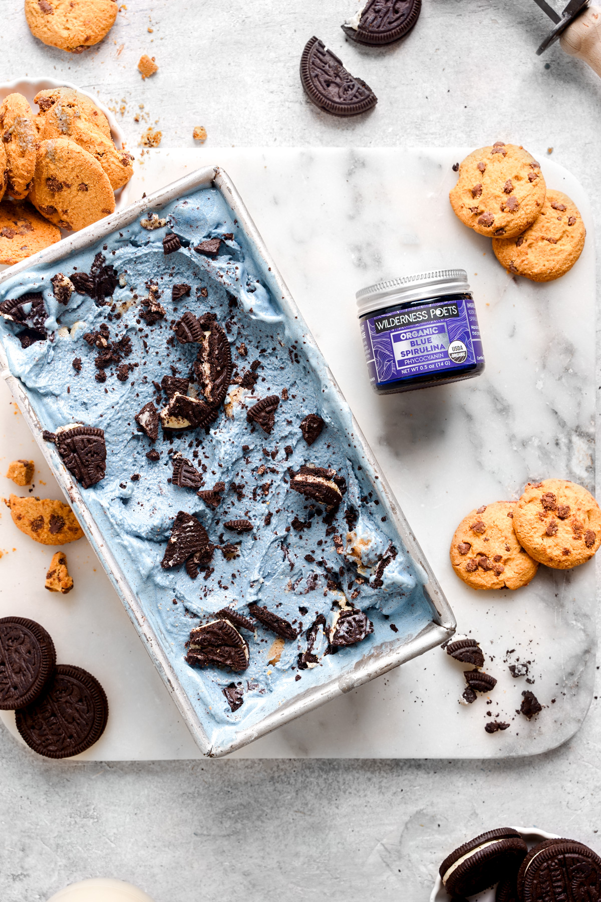 the cookie monster ice cream with the wilderness poets blue spirulina next to it