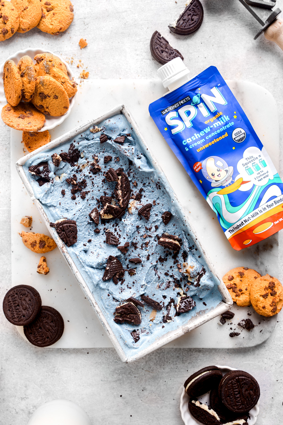 looking down at the cookie monster ice cream with the wilderness poets spin nut milk concentrate next to it