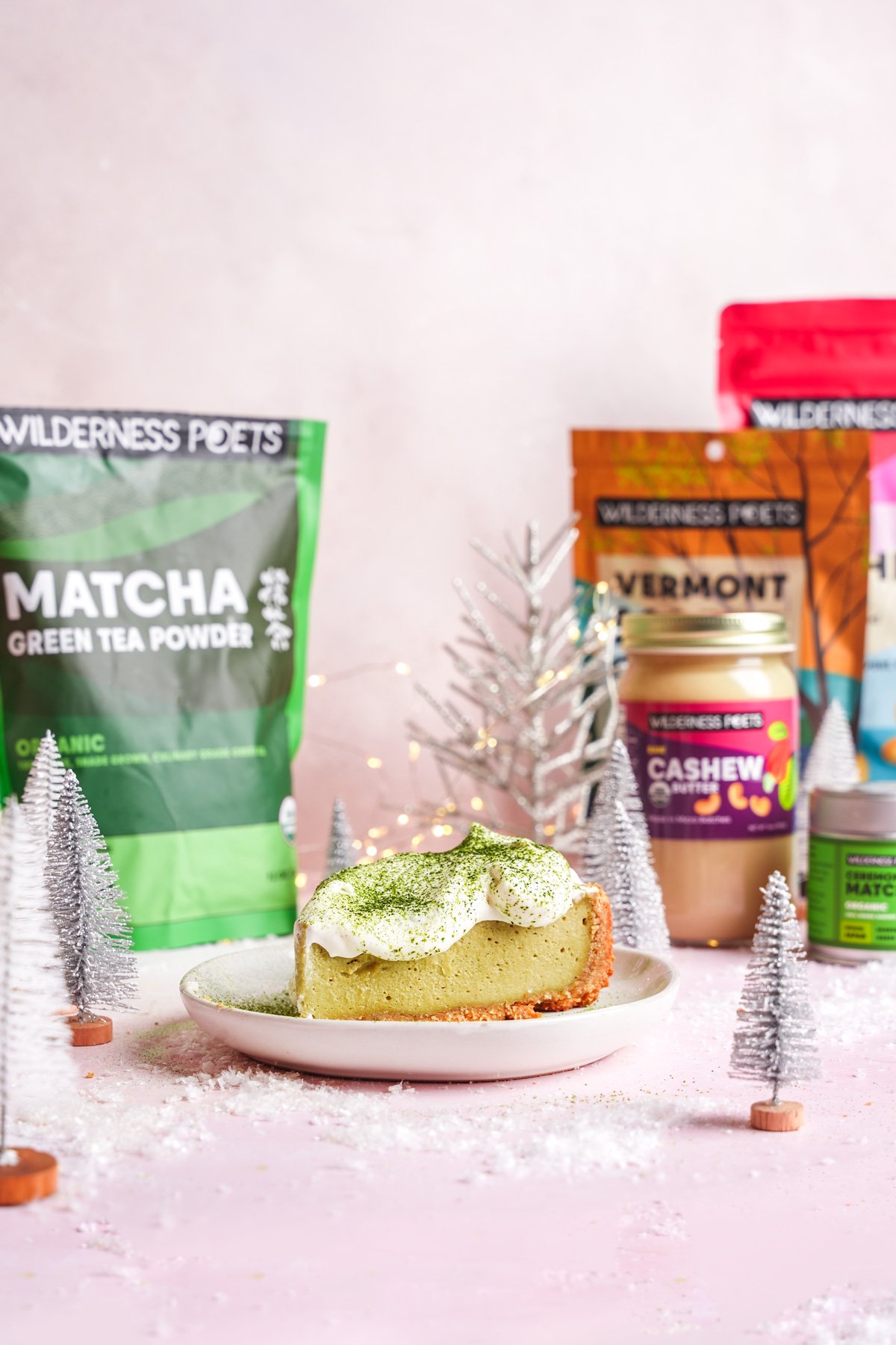 a slice of the vegan matcha cheesecake with the wilderness poets products