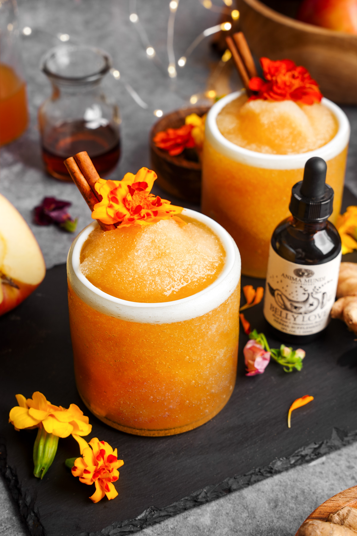 the frozen apple cider mocktail next to the anima mundi belly love