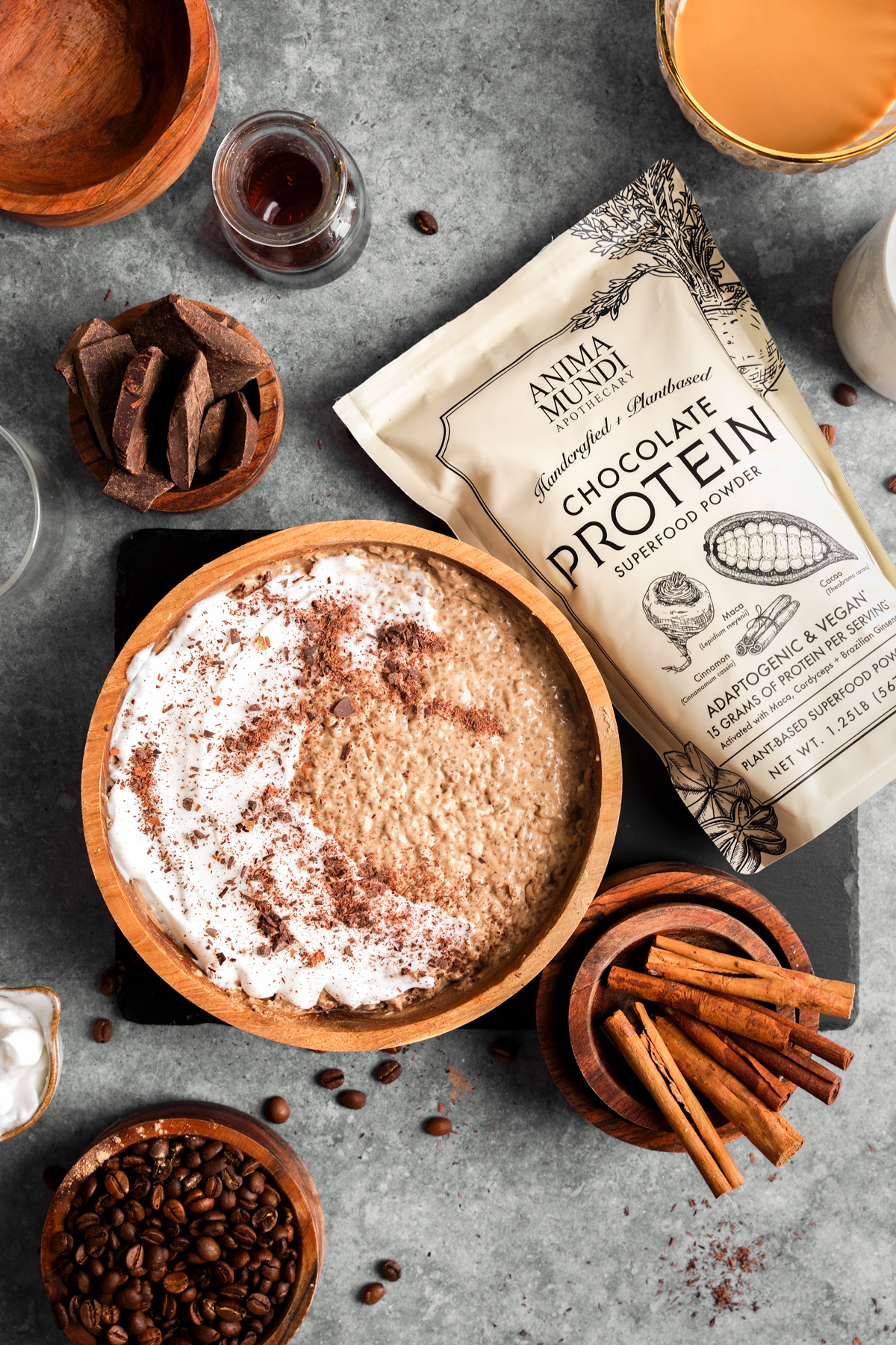 the coffee chia seed protein pudding in a bowl next to the anima mundi protein powder