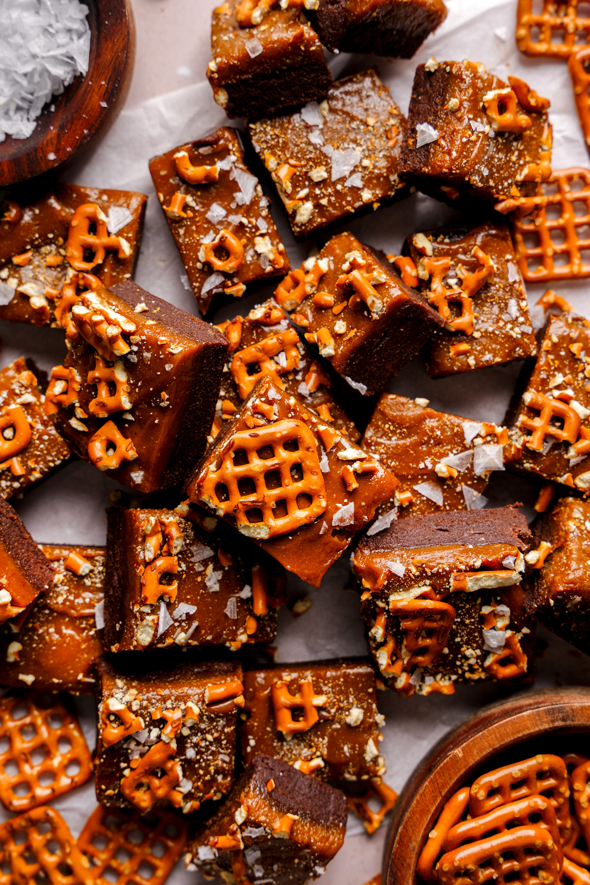 the date fudge stacked on top of each other with pretzels broken on top